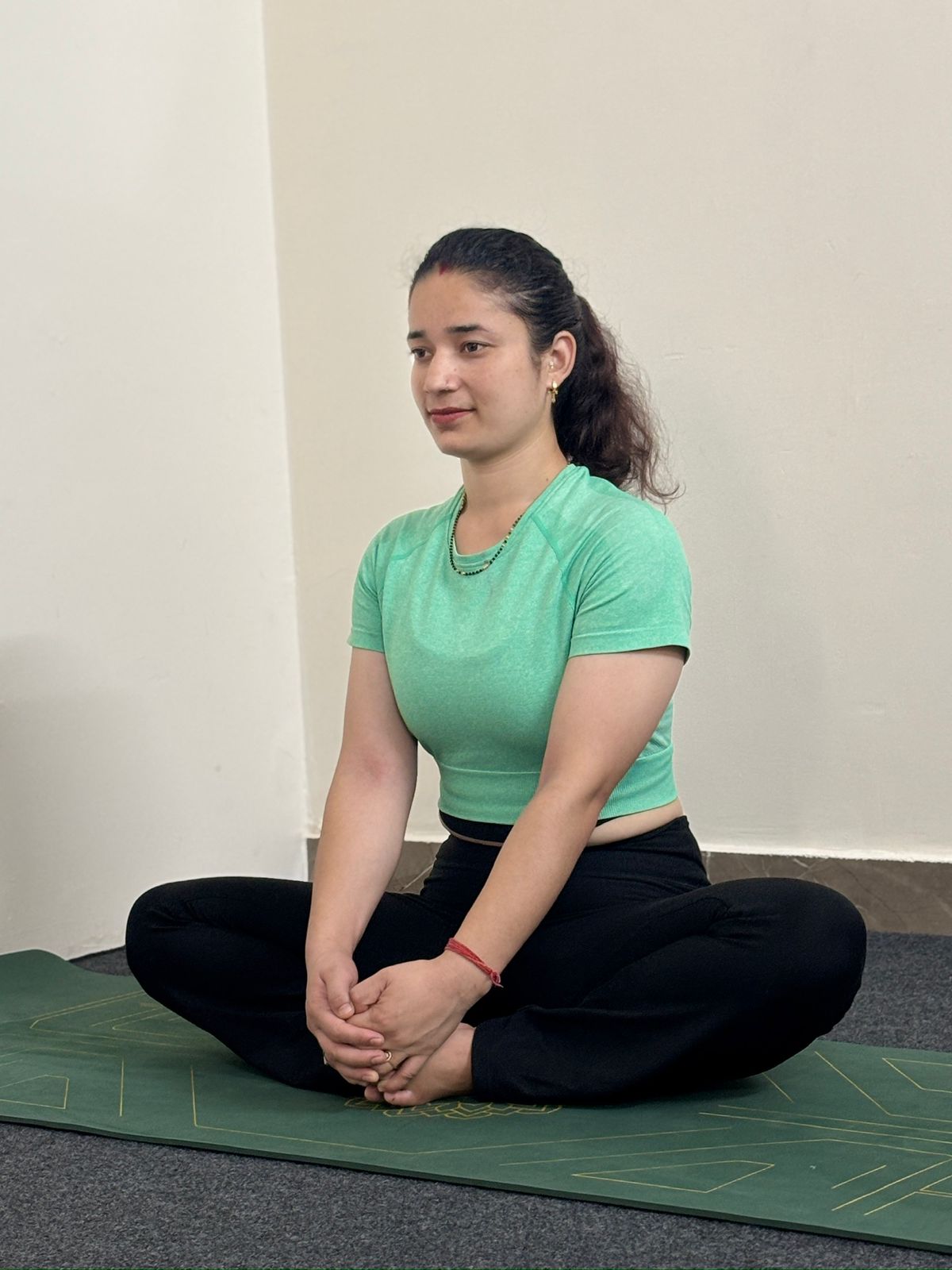 Professional headshot of Anjali Negi, a certified Hatha and Vinyasa yoga instructor.
